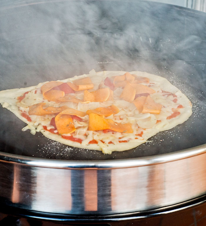 Butternut, onion, bell pepper and roasted garlic pizza on the BBQ